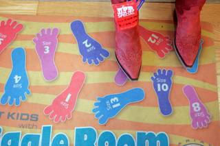 Kristin Davis tries on red boots at the Boot Barn.