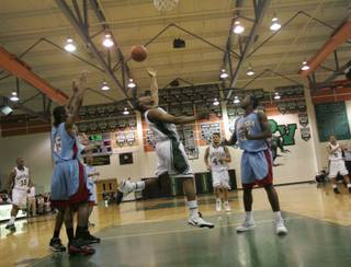 Palo Verde senior D.J. Stennis (1), center, throws up an acrobatic shot during the Sunset Regional quarterfinals against Western on Tuesday night.