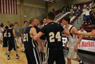 Boulder City's Joey Western (20), left, and Faith Lutheran's Nate McMurran (4), right, argue after their 3A Southern League basketball tournament game at Desert Oasis High Thursday.
