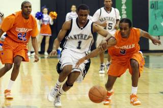 Palo Verde point guard D.J. Stennis attempts to grab hold of the ball as Bishop Gorman guard Kylel Coleman steals during the boys Sunset Regional championship game at Palo Verde High School on Friday.