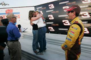 Kyle Busch stands in as best man as Damon Landry and Heather Wilson are wed by track chaplain Bruce Brown after qualifying for the Shelby 427 Sprint Cup race at the Las Vegas Motor Speedway Friday, February 27, 2009. Landry and Wilson were in the middle of their wedding ceremony in winner's circle when Busch arrived for a photo session. When Busch noticed the ceremony taking place, he left the photographers and stood in as best man for Landry.