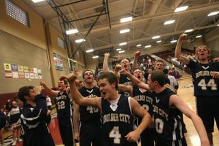 Boulder City's basketball team celebrates its 59-56 victory over Lowry in the 3A state semifinals at Desert Oasis High School Friday.
