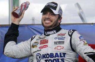 Jimmie Johnson celebrates in Victory Lane after winning the NASCAR Sprint Cup Series Shelby American GT 350 auto race at the Las Vegas Motor Speedway Sunday, February 28, 2010.