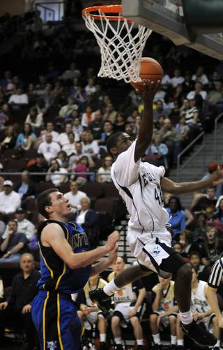 Lake Mead Christian Academy guard De'quan Thompson is shoved by Panther defender Taylor Poulson while scoring a layup during the class 1A state final game at the Orleans Arena on Saturday afternoon.