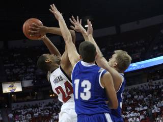 Rene Rougeau gets a shot over two defenders Wednesday night as UNLV takes on Air Force at the Thomas & Mack Center.  It was the last game of the regular season and Senior Night for the Rebels, who came out on top 46-43.