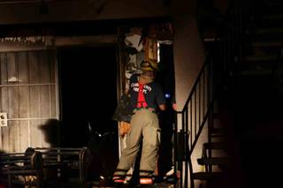 Two people were hospitalized for smoke inhalation Thursday night after a couch caught fire outside their northeast Las Valley Valley home. 

