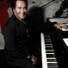 Wayne Newton, seated comfortably at the piano.
