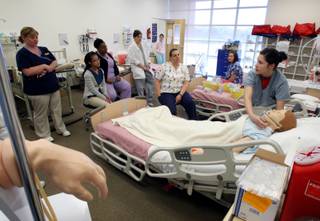 Nursing student and respiratory therapist Jill Petersen, right, puts an oxygen mask on a medical mannequin during a Fundamentals Skills Lab at the Nevada State College in Henderson on Wednesday, March 11, 2009. Nevada State College was hitting 80 percent licensure examination pass rates in 2008. Graduates of two of Nevada's newest nursing schools have licensure examination pass rates hovering at around 60 percent, well below the standard 80 percent plus. 