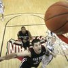 San Diego State forward Ryan Amoroso and BYU guard Lee Cummard watch Amoroso's shot roll in during their semifinal game at the Mountain West Conference Basketball Championships Friday. San Diego State won 64-62 and will face Utah for a shot at the championship and an automatic berth to the NCAA Tournament. Amoroso had nine points and two rebounds for the game. 