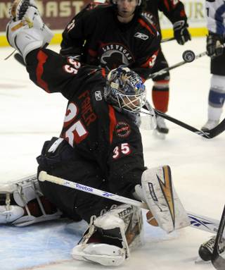 Las Vegas Wranglers goalie Glenn Fisher deflects an Idaho shot into the air during first period action at the Orleans Arena on Friday night. The Wranglers won 4-1.