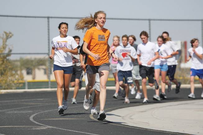 Coronado senior Michaelanne Laurent leads the pack while running the mile with her teammates during cross-country practice.