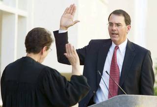 UNLV law professor Jay S. Bybee, shown during his October 2003 swearing-in as a judge on the U.S. Court of Appeals for the Ninth Circuit, is awaiting the results of a Justice Department investigation into whether his opinions on torture are consistent with standards of professional conduct.