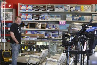 Jeff Whittle checks out the seating and boat motors during the liquidation sale Saturday at Boater's World, 470 N. Stephanie Street, in Henderson.  Boater's World, owned by Ritz Camera Centers, plans to close all stores nationwide within 90 days as part of its bankruptcy reorganization.
