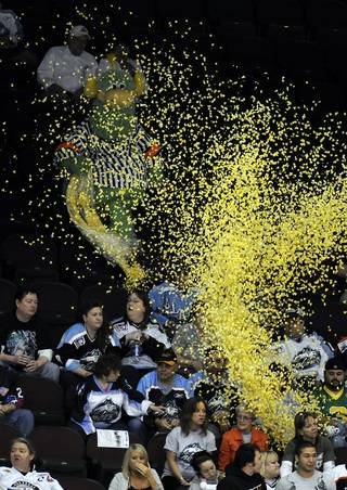 The Las Vegas Wranglers' mascot, The Duke, showers a section of visiting Alaska Aces fans with popcorn late in the game Tuesday night.