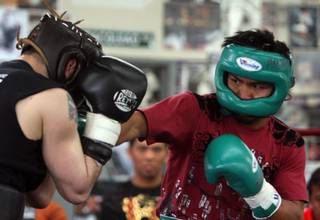 Manny Pacquiao, right, spars with Gary Young as he prepares for his fight with Ricky Hatton at the Wild Card Boxing Club in Hollywood, California March 31, 2009. Pacquiao of Philippines will take on Hatton of England in a 12-round fight at the MGM Grand Garden Arena on May 2.