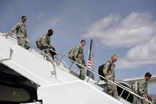 A group of airman deplane upon returning to Nellis Air Force Base on Wednesday after an eight-month deployment and combat duty in Iraq.