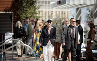 Hugh Hefner enters with his entourage during Hefner's 83rd birthday party at the Palms Place pool in Las Vegas Saturday, April 4, 2009. 
