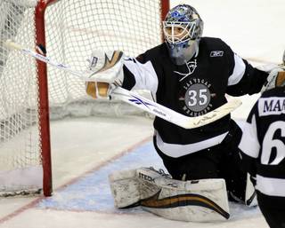 Wranglers netminder Glenn Fisher watches the puck after deflecting it with his blocker during the third period against the Thunder at the Orleans Arena. Fisher made 35 saves Saturday night.