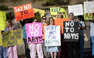 Health advocates rally in opposition of Assembly Bill 495 in front of the Grant Sawyer State Office building in Las Vegas Monday morning.

