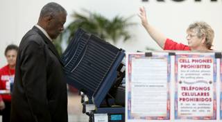 Volunteer Linda Daniel calls for the next voter as Sam Roberson casts his vote in the municipal primary election Tuesday at the Galleria Mall.