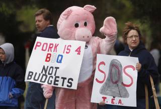 Brian Canfield, center, joins other protesters on Eastern Avenue during a tax protest 