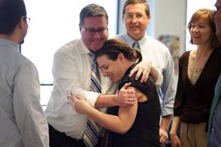 Reporter Joe Brown embraces reporter Alexandra Berzon as she returns to the newsroom and learns of the Las Vegas Sun's win of the Pulitzer Prize for public service for exposing a high death rate among construction workers on the Las Vegas Strip, at the Las Vegas Sun offices in Henderson, Nevada on Monday, April 20, 2009. 