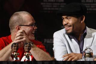 Junior welterweight boxer Manny Pacquiao, right, of Philippines talks with his trainer Freddie Roach during a news conference at the MGM Grand Hotel and Casino in Las Vegas, Nevada April 29, 2009. Pacquiao will face Ricky Hatton of England for a 12-round bout at the MGM Grand Garden Arena on Saturday. STEVE MARCUS / LAS VEGAS SUN