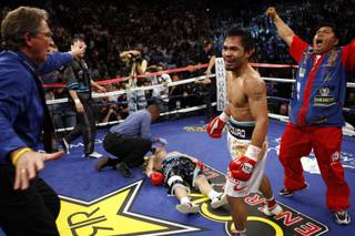 Referee Kenny Bayless checks on Ricky Hatton after Manny Pacquiao knocked 