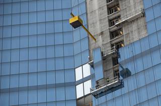 Employees of Z Glass install the glass panels that make up the exterior of the Fountainbleau hotel and casino.