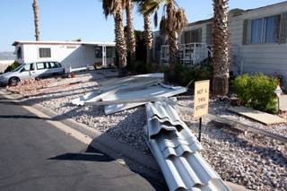Debris lays on the side of the road after a dust devil blew roofing material off mobile homes, awnings and carports in Gingerwood Mobile Home Park.