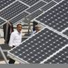 Photo: President Barack Obama looks at solar panels at Ne Photo: President Barack Obama looks at solar panels at Ne