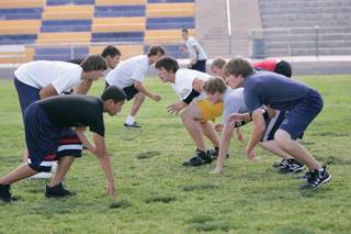 Boulder City's football team runs through drills without pads to prepare for the upcoming season.