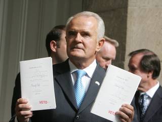 Gov. Jim Gibbons holds up AB552 and SB433 after he vetoed the bills on the Capitol steps in Carson City at the Nevada Legislature on Thursday, May 28, 2009.