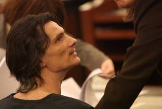 Convicted child molester Chester A. Stiles talks to one of his attorneys May 29 just before he was sentenced to life in prison on 21 of 22 charges.