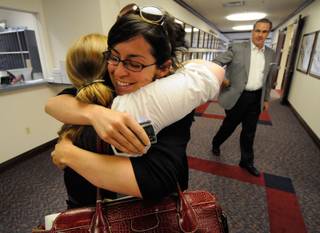 Rebecca Gasca, public advocate for ACLU of Nevada, hugs Lee Rowland, northern coordinator for the ACLU of Nevada, shortly after the Nevada Assembly overrode the governor's veto of Senate Bill 283 at the Nevada Legislature on Sunday in Carson City.  Also pictured is Greg Ferraro with the Nevada Resort Association.  