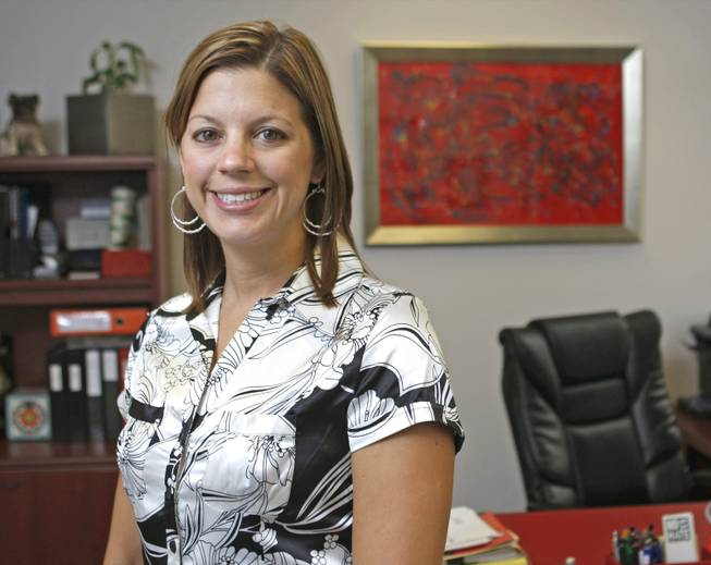 Elizabeth Sorokac is shown in her office. After Sorokac was laid off from her law firm, she started her own firm.