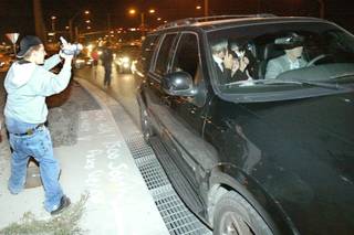 Michael Jackson and members of his entourage ride inside a vehicle just outside the Green Valley Ranch Casino in Henderson on Nov. 20, 2003. Jackson left Las Vegas on that morning and flew to Santa Barbara, Calif., to turn himself in to authorities on charges of child molestation. He landed at the Henderson Executive Airport that afternoon and drove around Las Vegas and Henderson in a black sport utility vehicle for more than two hours. 