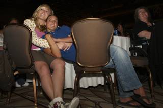 Six-year partners Karlie Gabour, 23, and Savannah Miele, 22, cuddle in each others' arms while listening to speakers during a domestic partnership celebration Thursday at the Rio. Gabour and Miele look forward to their opportunity to register as domestic partners Oct. 1.