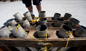 Grucci's of New York technicians set up fireworks on the Texas Station parking garage Friday in preparation for Station Casinos' nine-property fireworks show on Saturday.