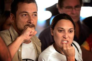 Ben Renard-Wiart, left, and Sarah Gordan, both of Logan, Utah, cheer on player John Seiter during the World Series of Poker Main Event at the Rio.