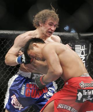 Alan Belcher hits Yoshihiro Akiyama with a shot to the head during their fight at UFC 100.