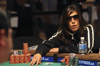 Leo Margets, the lone woman standing, places a bet Tuesday during the 7th day of competition at the World Series of Poker Main Event at the Rio.