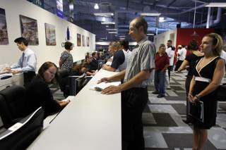 Steve Baker, center, inquires about cook positions during a food and beverage job fair at the CityCenter Career Center on Thursday. Nicole Huerta, right, applied for a cocktail position. When completed, the MGM Mirage project is expected to employ 12,000 people.