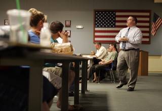 Shane Watson, right, vice president of Direct Access Lending and a community outreach advocate, speaks during a free seminar on home foreclosure issues at the Jerry Keller Training Center, 9880 W. Cheyenne Ave., Tuesday, July 28, 2009. 