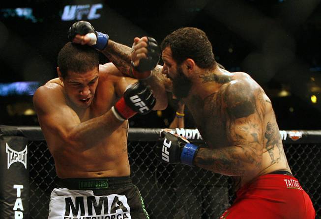 Fans of mixed martial arts and the UFC, Ultimate Fighting Championship gather at the Wachovia Center on Saturday evening August 8, 2009 for a night of fighting. Battle between middleweights Alessio Sakara and Thales Leites. Winner Sakara. (with beard) Sakara is pictured at right punching Leites.