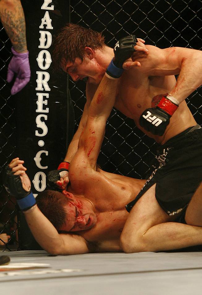 Fans of mixed martial arts and the UFC, Ultimate Fighting Championship gather at the Wachovia Center on Saturday evening August 8, 2009 for a night of fighting. Battle between welterweights Matthew Riddle and Dan Cramer. Winner is Riddle. Riddle is on top.