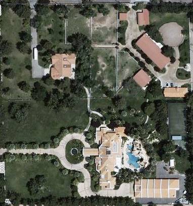 The property is bordered by Tomiyasu Lane to the west and Maule Avenue to the north. The main gate, off Tomiyasu, leads up the circular driveway to the main residence (with pool in back). At the southeast corner is the car museum. The northeast quadrant includes equestrian and canine facilities. The building to the northwest, with a gated driveway on Maule, is a 3,000-square-foot guest villa.