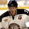 Photo: Jason Krischuk focuses on the puck during a game a Photo: Jason Krischuk focuses on the puck during a game a