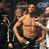 Randy Couture, center, along with his trainers (left to right) Quentin "The Dragon" Chong and Shawn Thompkins, talks with Joe Rogan during Friday's weigh-in for UFC 102 Saturday night at the Rose Garden Arena in Portland, Ore., in August.