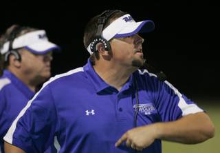 Basic High School coach Jeff Cahill yells to his players during the second half of their game against Boulder City on Friday. Basic won the game 26-0.